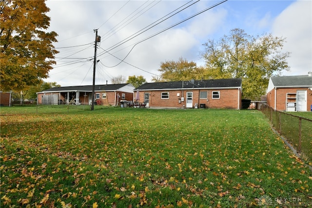 back of house featuring a yard