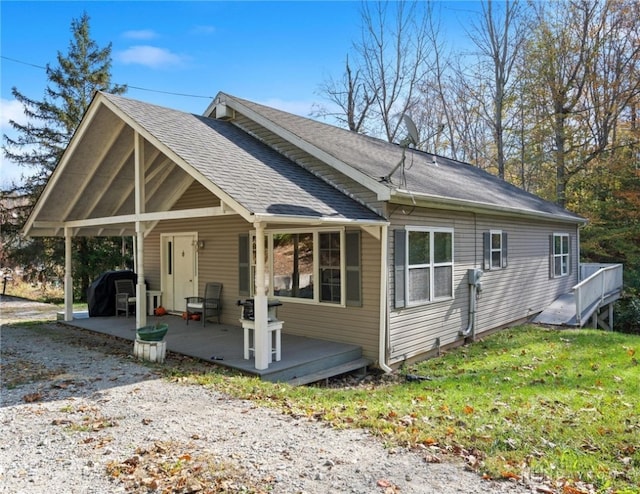 view of front of property featuring a patio and a wooden deck