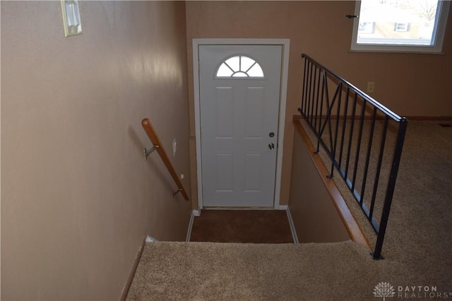 entryway featuring dark colored carpet