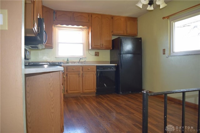 kitchen featuring ceiling fan, sink, black appliances, and dark hardwood / wood-style floors