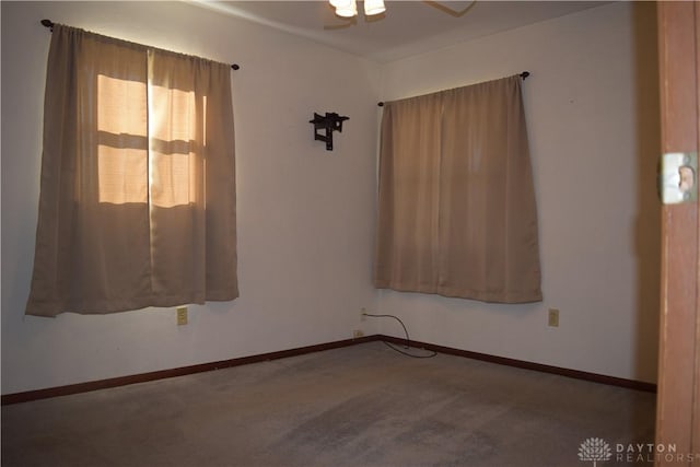 spare room featuring ceiling fan and carpet floors