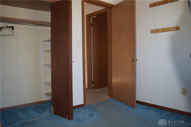 unfurnished bedroom featuring carpet flooring and a closet