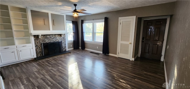 unfurnished living room with dark wood-type flooring, ceiling fan, and a textured ceiling