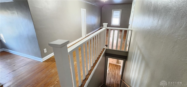 stairs featuring hardwood / wood-style floors