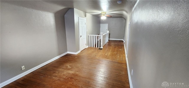 hallway with hardwood / wood-style floors