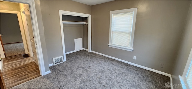 unfurnished bedroom featuring carpet and a closet