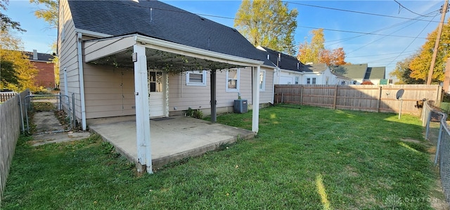 view of yard featuring central air condition unit and a patio area