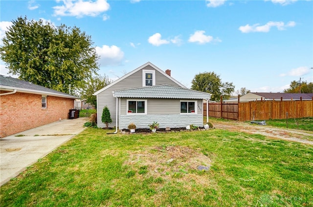 back of house with a yard