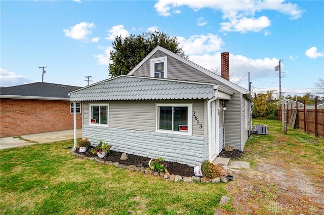 back of house featuring central AC, a yard, and a patio area