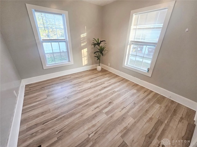 unfurnished room with light wood-type flooring