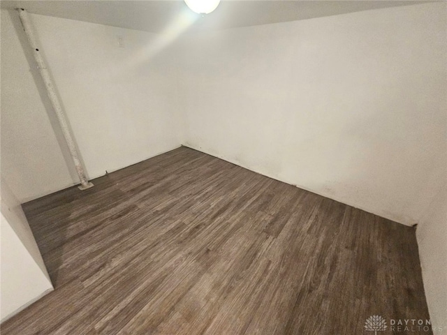 empty room with dark wood-type flooring