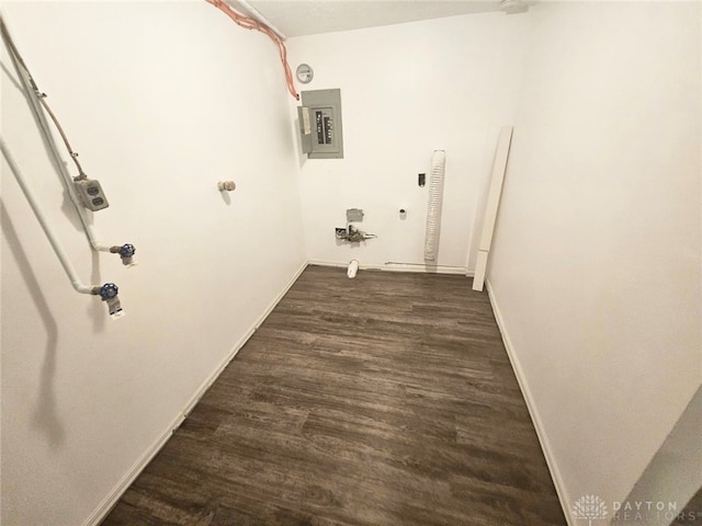 clothes washing area with electric panel and dark hardwood / wood-style flooring