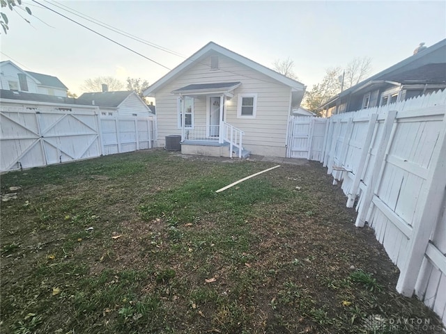 rear view of house with central AC unit