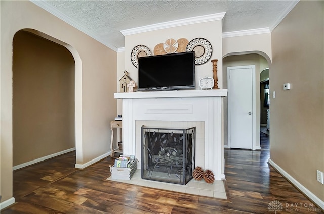 unfurnished living room with dark hardwood / wood-style floors, ornamental molding, and a textured ceiling