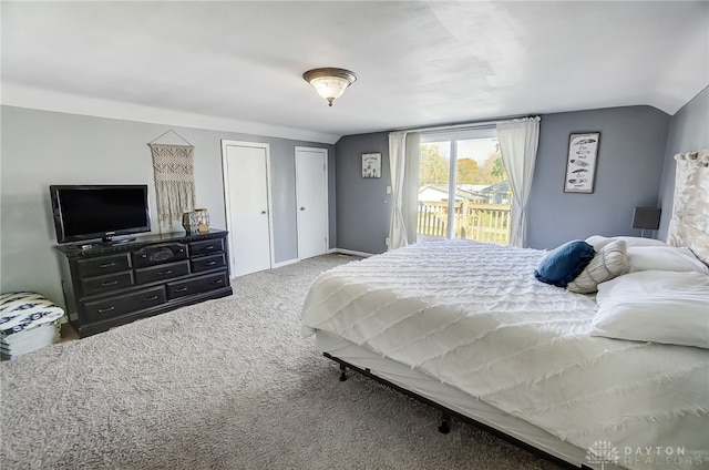 bedroom with carpet flooring, access to exterior, and vaulted ceiling