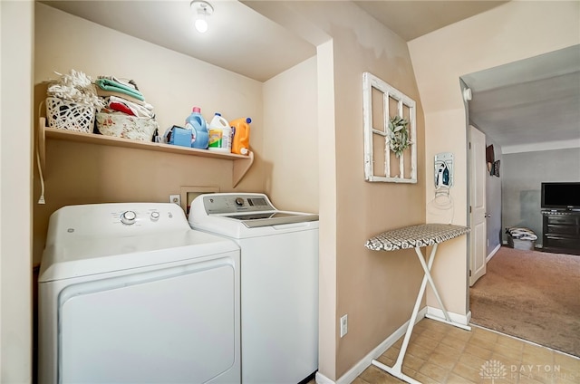 washroom featuring washer and clothes dryer and light colored carpet