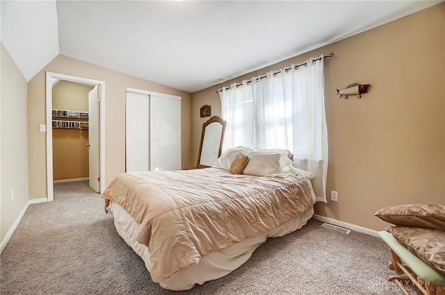 carpeted bedroom with lofted ceiling