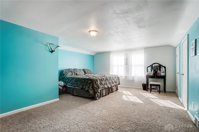 bedroom with carpet and lofted ceiling