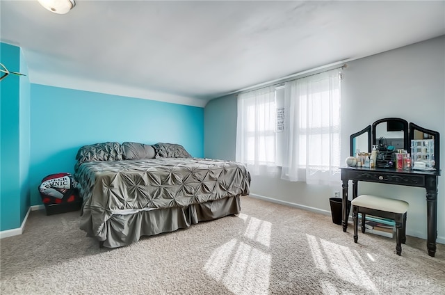 carpeted bedroom featuring lofted ceiling