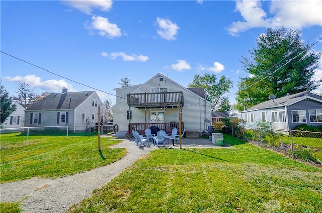 rear view of property with a patio and a lawn