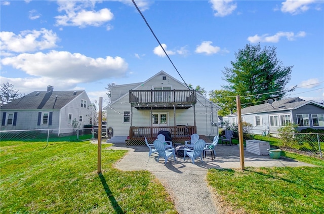 back of property featuring a patio, a deck, and a lawn