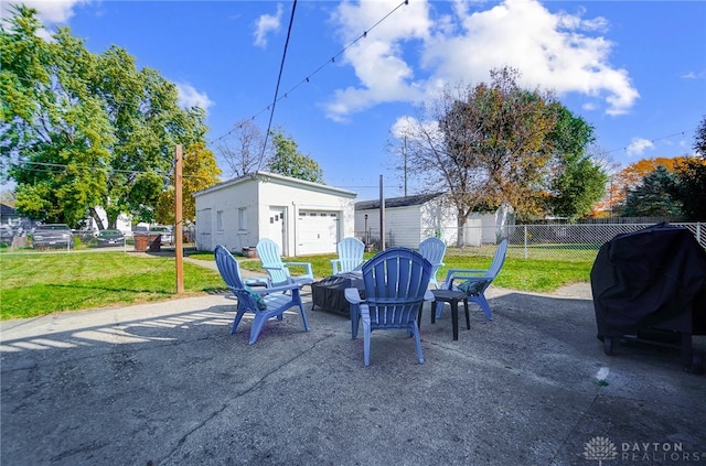 view of patio / terrace featuring an outbuilding, a fire pit, grilling area, and a garage