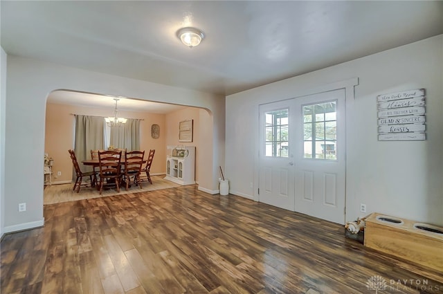 foyer with a notable chandelier and dark hardwood / wood-style floors