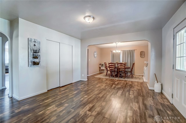 dining space featuring dark hardwood / wood-style flooring and a chandelier