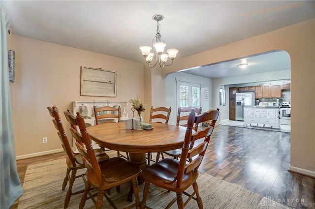 dining space with a chandelier and hardwood / wood-style flooring