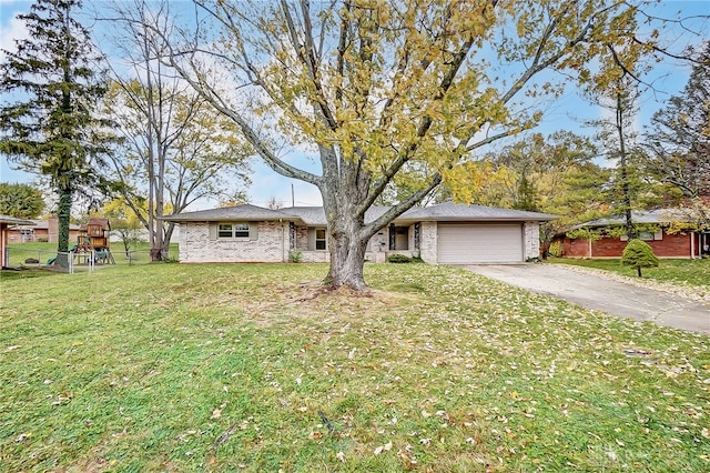 single story home with a garage and a front lawn