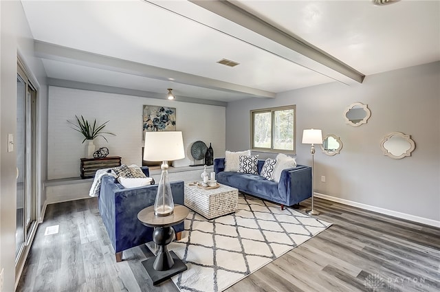 living room featuring beam ceiling and hardwood / wood-style flooring