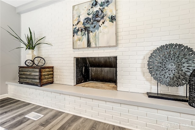 interior details with hardwood / wood-style floors and a fireplace