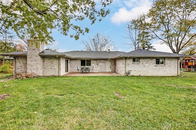 rear view of house with a patio area and a yard