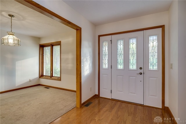 foyer entrance with light hardwood / wood-style flooring and plenty of natural light