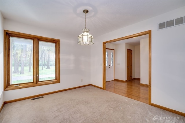 carpeted empty room featuring plenty of natural light