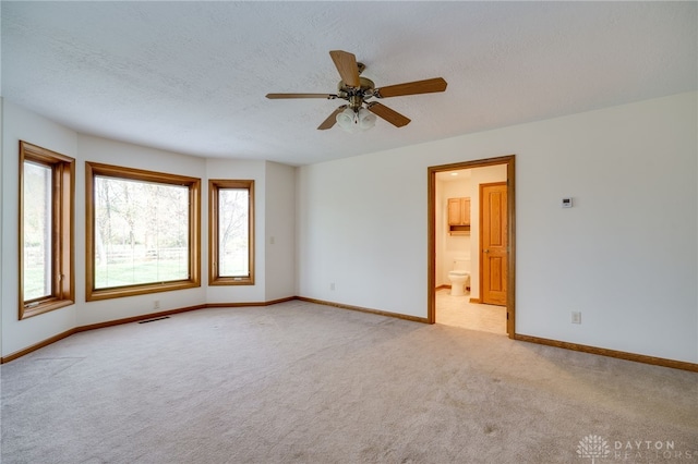 spare room with light carpet and ceiling fan