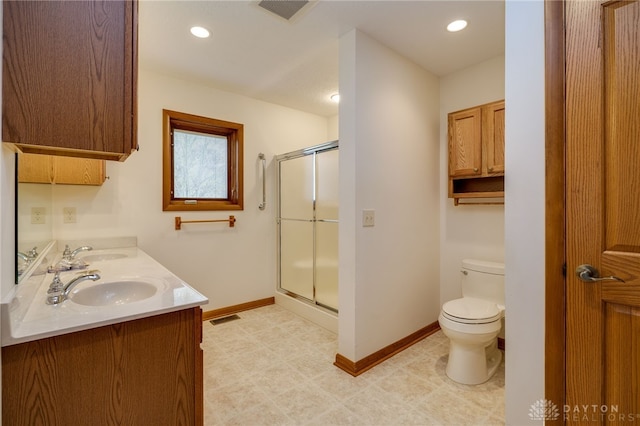 bathroom featuring vanity, an enclosed shower, and toilet