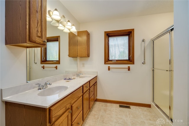 bathroom featuring vanity and a shower with door