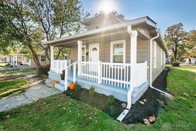 view of front of house with a porch and a front yard