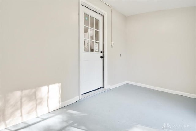 interior space with finished concrete floors and baseboards