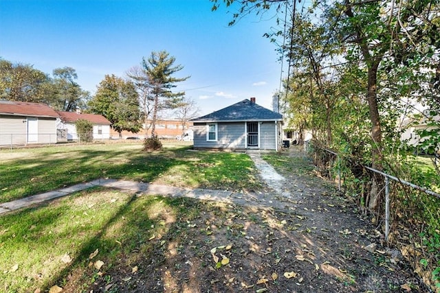 back of house with a yard and fence