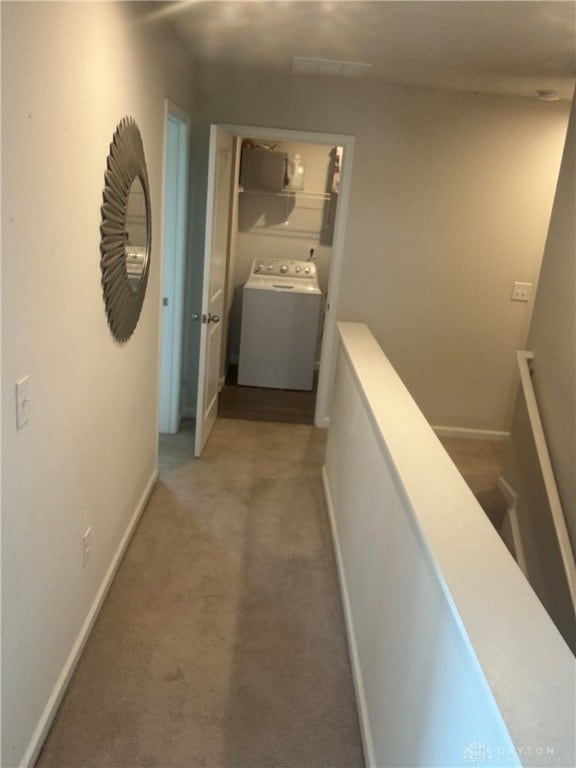 corridor with carpet and washer / dryer