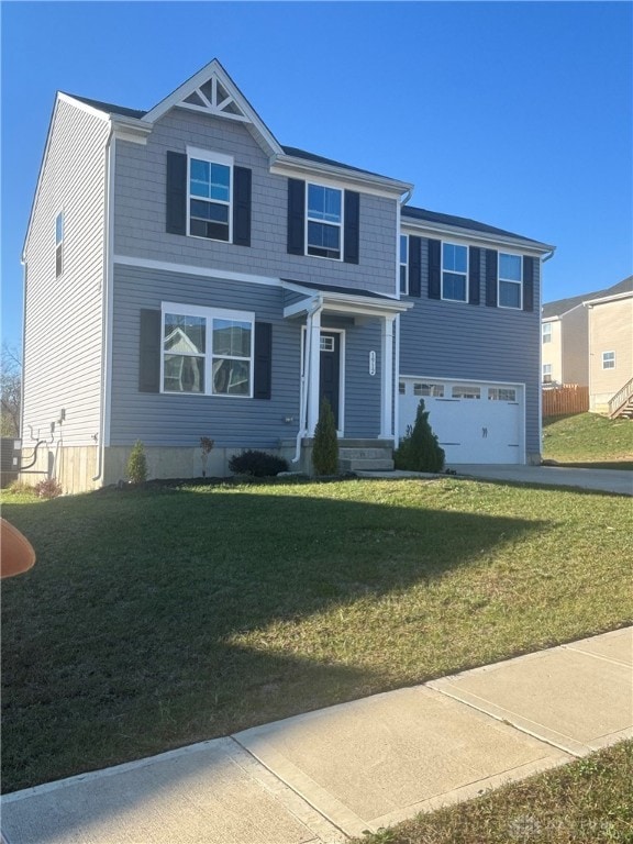 view of front of house with a garage and a front lawn