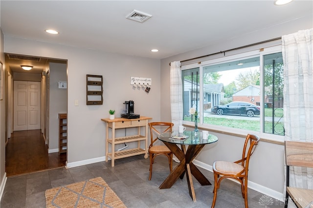 dining space with dark hardwood / wood-style flooring