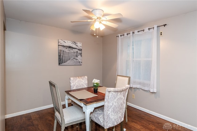 dining space with dark wood-type flooring and ceiling fan