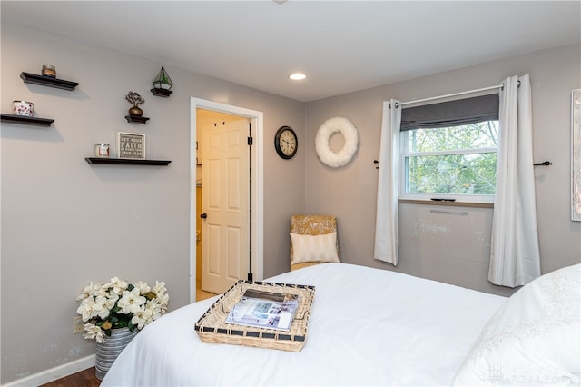 bedroom with hardwood / wood-style flooring