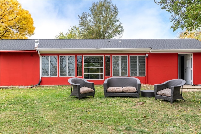 back of house featuring a lawn and outdoor lounge area