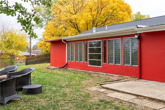 view of home's exterior with a yard and a patio area