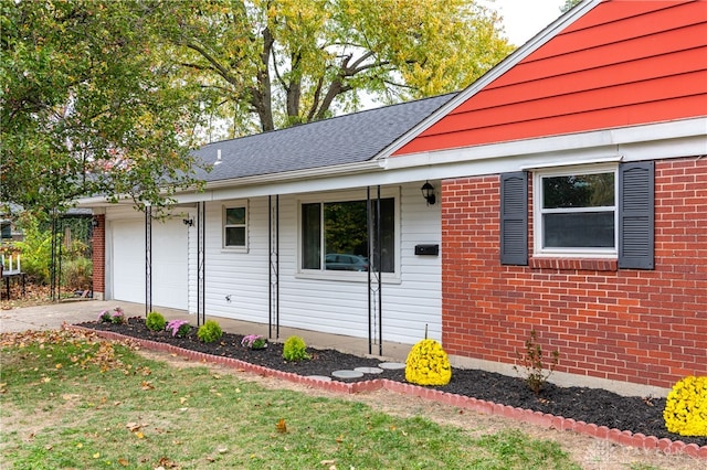 view of front facade with a front yard, covered porch, and a garage