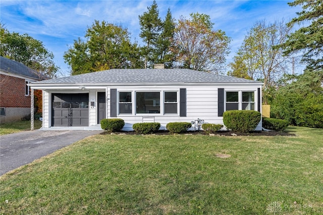 ranch-style house with a front yard and a garage